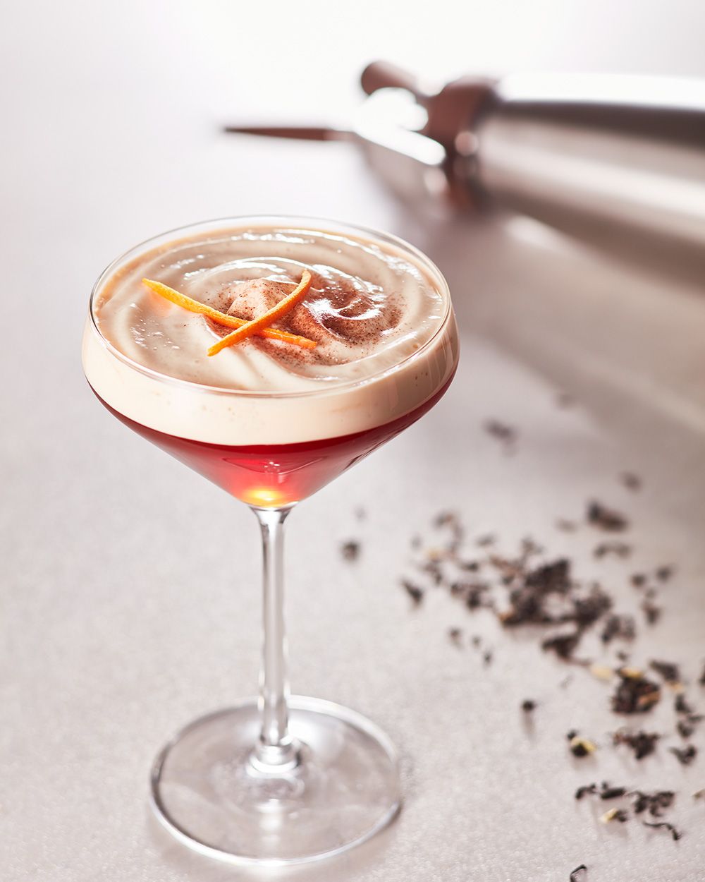 Ein Glas mit Nitro Chocolate Tea, daneben ein iSi Nitro.